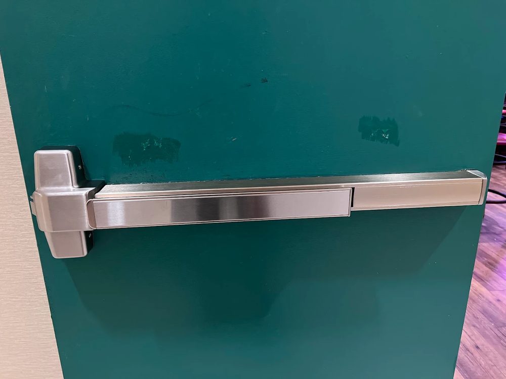 Push bar exit device installed on commercial door